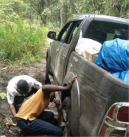 Octávio Longuenza and Paulino Mbundo dig their pick-up truck out of the mud in Lunda-sul Province, Angola.